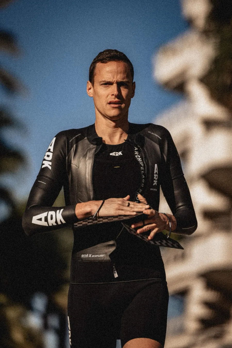 Hugo Tormento in swimrun wetsuit holding paddles